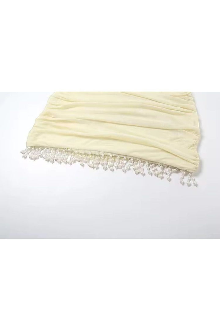 Mirae Paris butter yellow mini dress with ruched fabric and beaded hem. Feminine slim fit, perfect for summer.