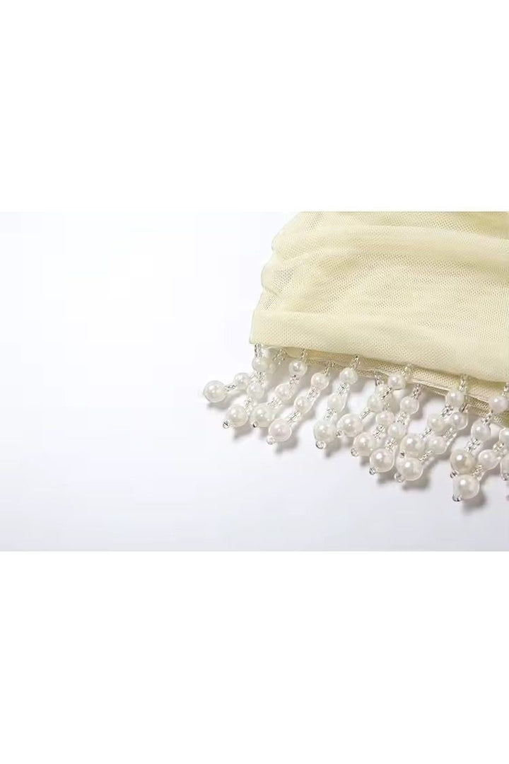 Mirae Paris butter yellow mini dress with pearl and bead fringe detail. Soft, feminine, and elegant.