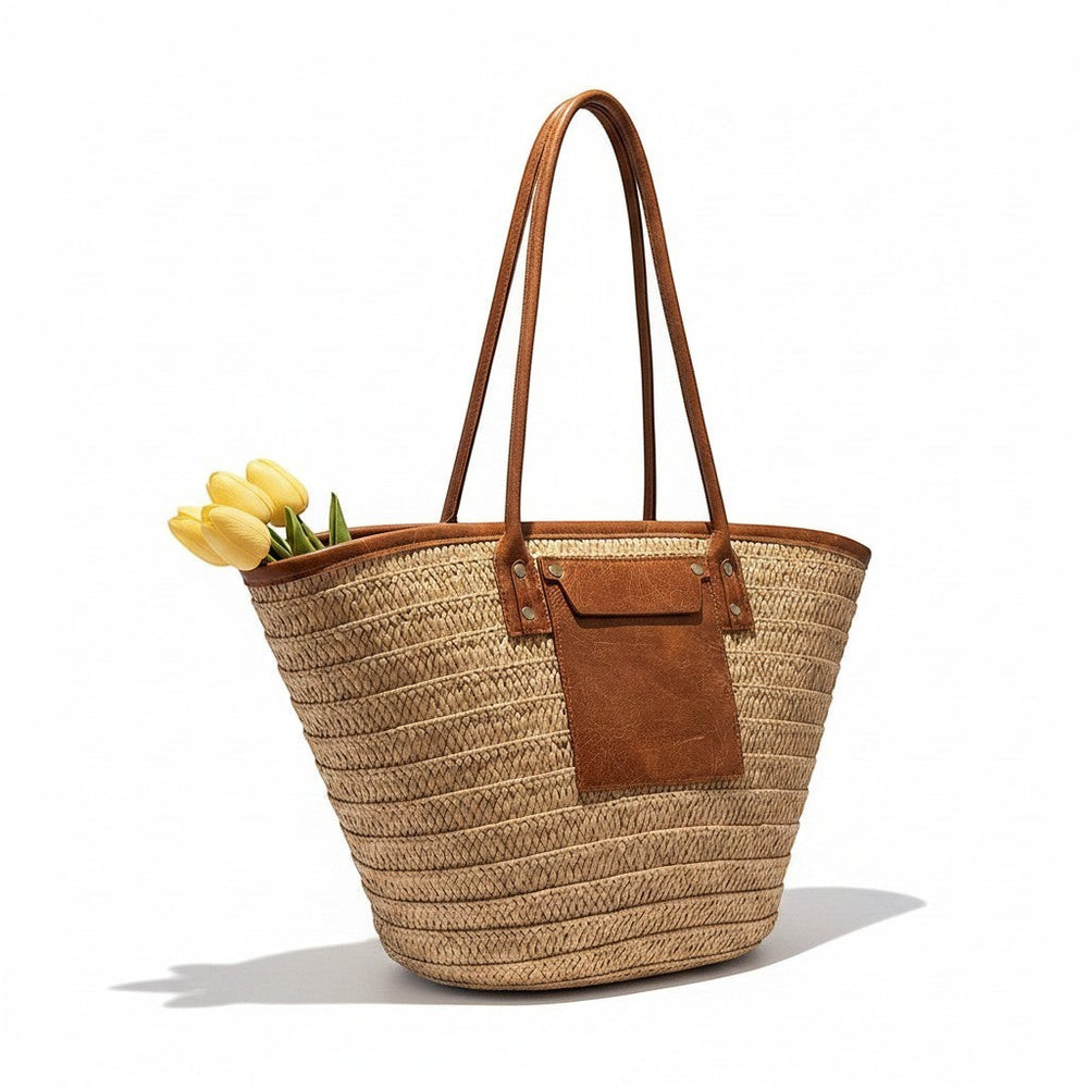 Miraee Paris Céleste boho straw tote bag with brown leather trim and handles, featuring yellow tulips inside.