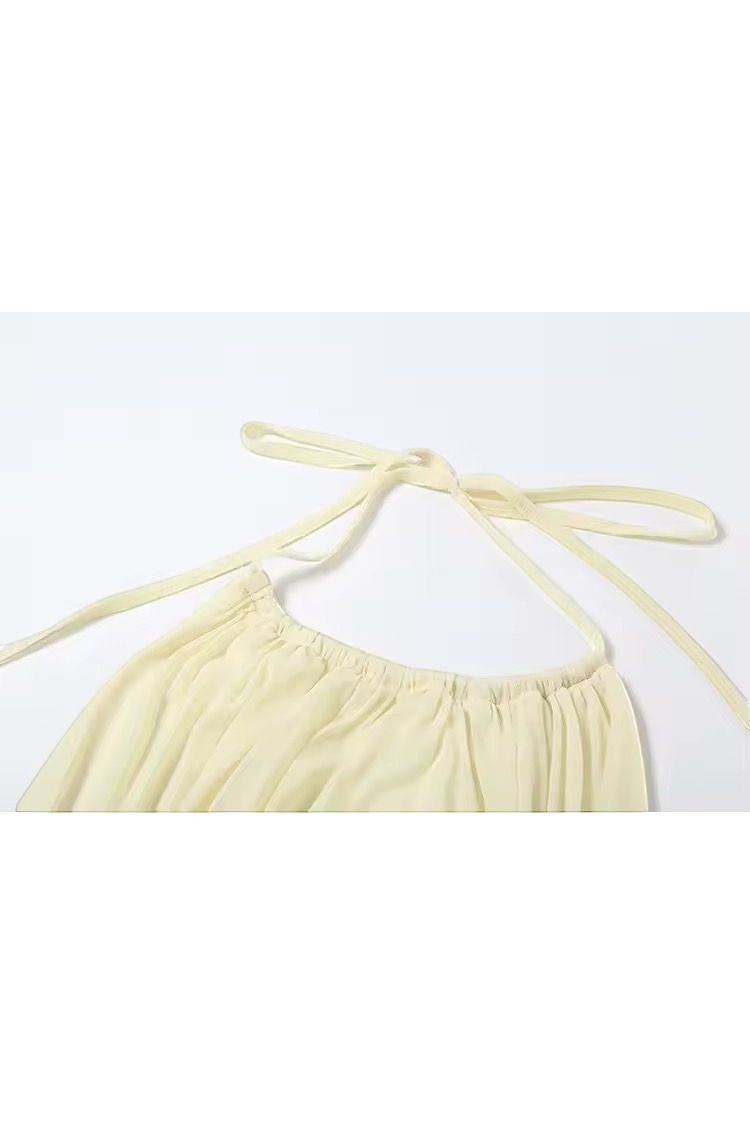 Miraee Paris butter yellow mini dress with halter neck and tie detail. Soft, lightweight polyester-elastane blend.
