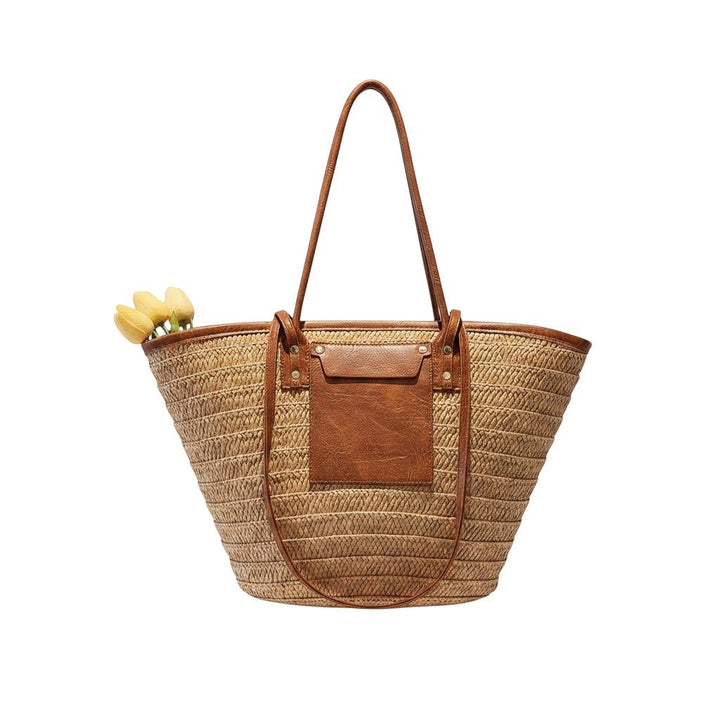 Miraee Paris Céleste boho beach tote bag in woven straw with brown leather-look trim and long shoulder straps.