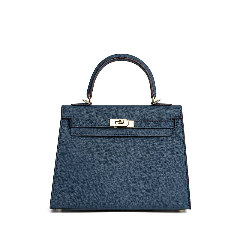 NAYA – Stylische Damenhandtasche in dunkelblauem Kunstleder mit goldenem Verschluss und Tragegriff.