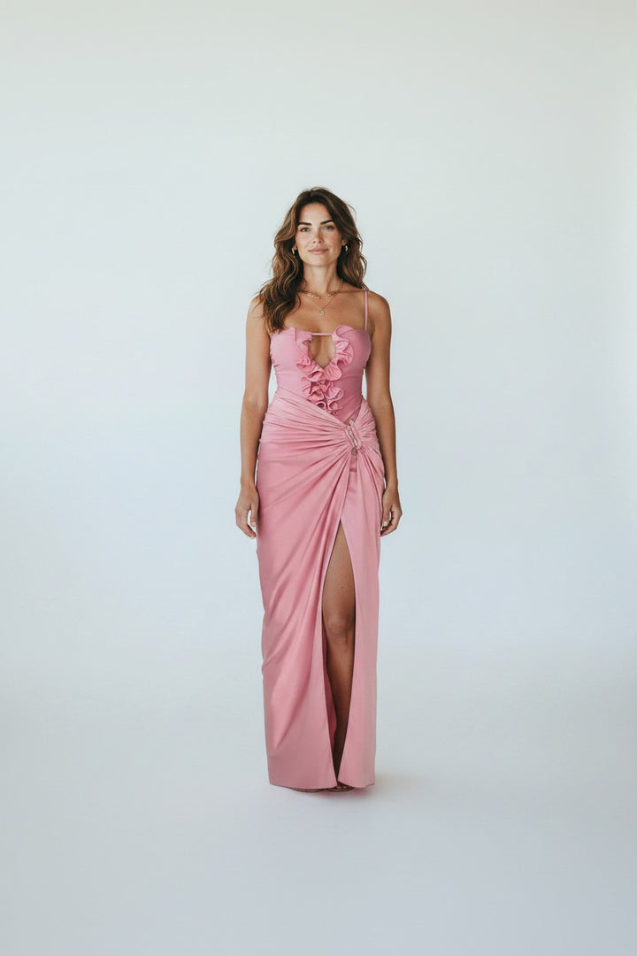 Miraee Paris Lara pink one-piece swimsuit with ruffled neckline and matching floor-length wrap cover-up skirt.