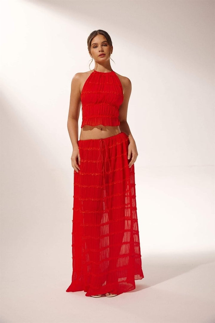 Miraee Paris red two-piece set featuring a pleated halter top and matching flowing maxi skirt in lightweight chiffon