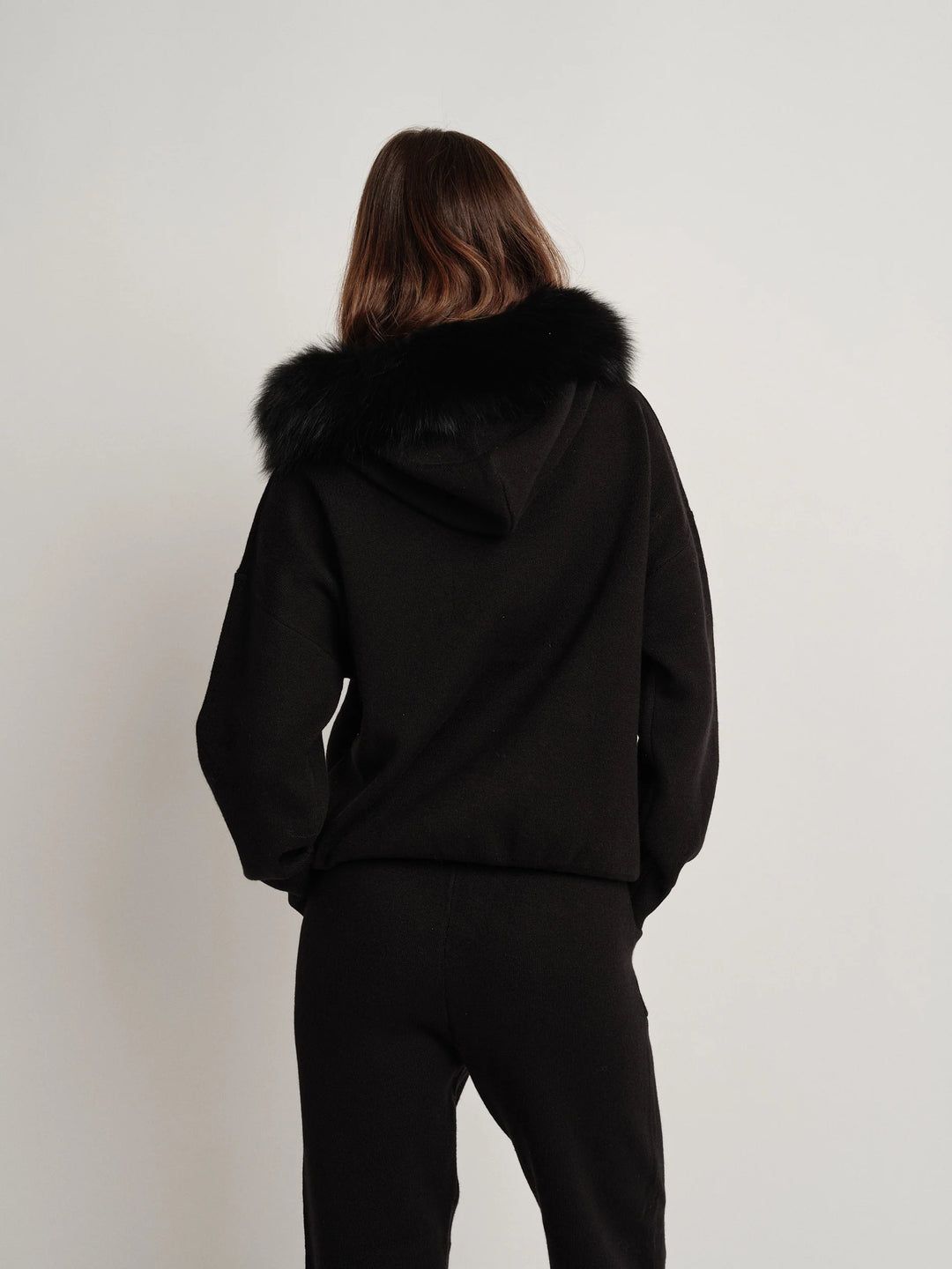 Bella Cashmere Lounge Set in black, featuring a luxurious fur-lined hoodie for stylish comfort.