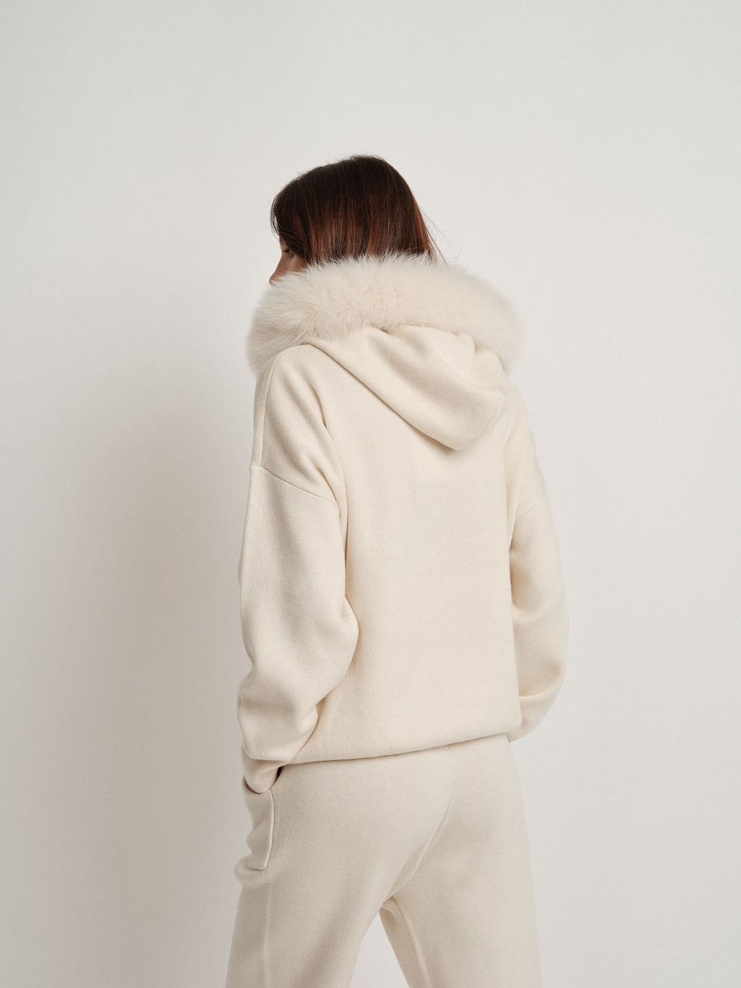 Bella Cashmere Lounge Set in cream with luxurious faux fur hood, perfect for stylish casual outfits.