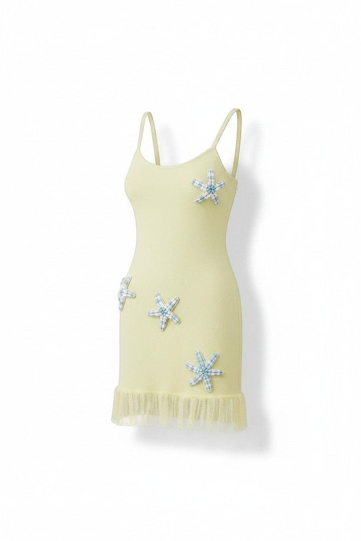 Miraee Paris Stella Mare lemon cream knit mini dress with spaghetti straps and decorative starfish embellishments.