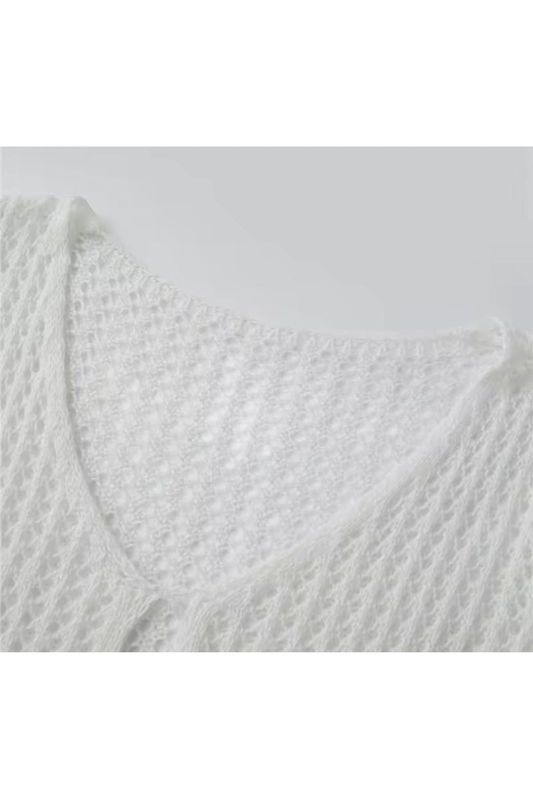 Miraee Paris white crochet beach cover-up featuring a delicate open-knit pattern and a feminine V-neckline.