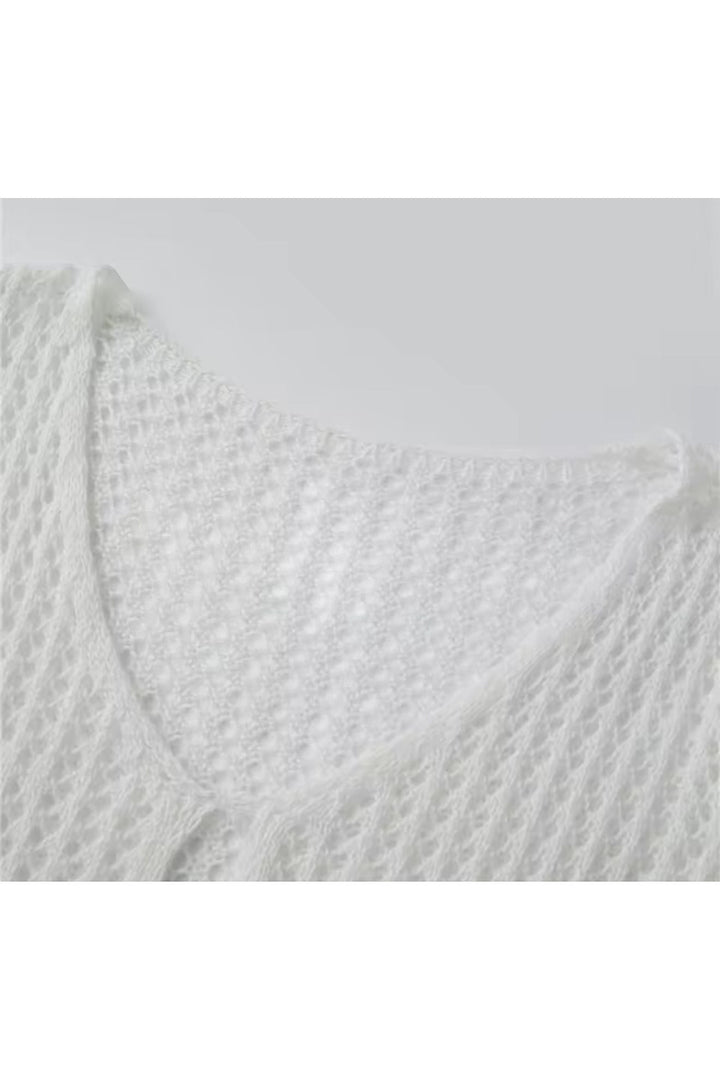 Miraee Paris white crochet beach cover-up featuring a delicate open-knit pattern and a feminine V-neckline.