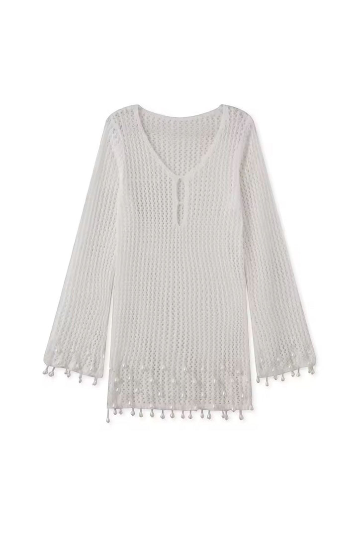 Miraee Paris white crochet beach cover-up with V-neck, long sleeves, and delicate tassel hem details.