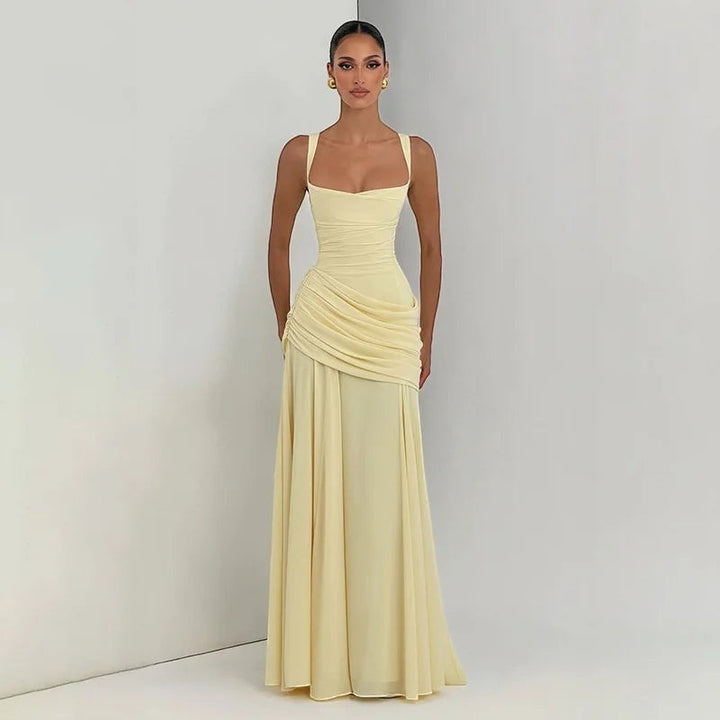 Miraee Paris elegant pale yellow maxi dress with a square neckline, draped waist, and flowing floor-length skirt.