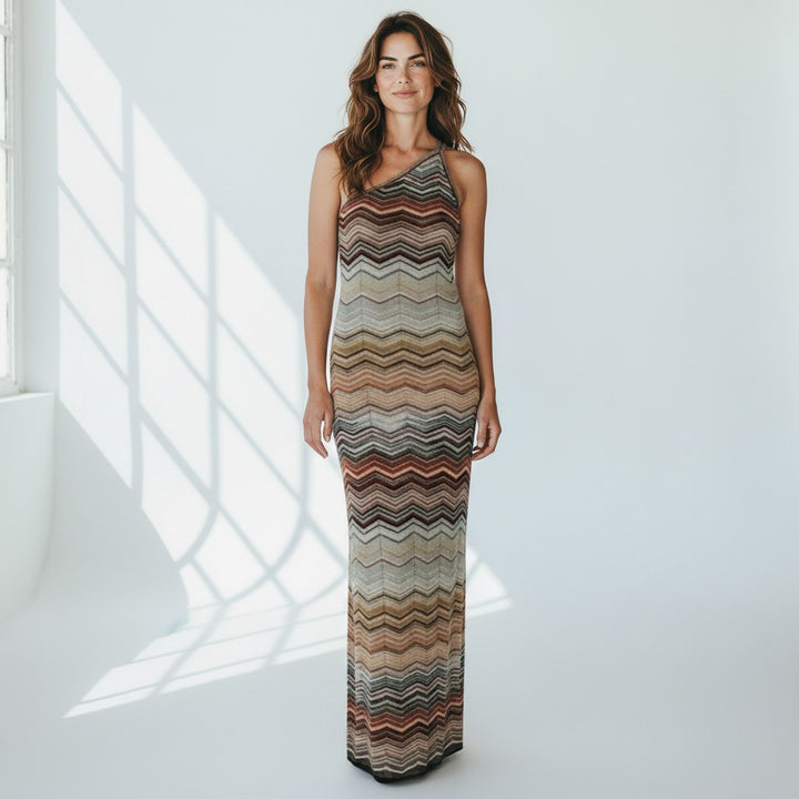Miraee Paris one-shoulder maxi dress in a teal green and earth-tone zigzag knit pattern with a slim bodycon fit.